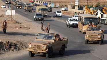 A convoy of Kurdish peshmerga fighters drive through Arbil after leaving a base in northern Iraq, on their way to the Syrian town of Kobani, Oct. 28, 2014.  (AFP)