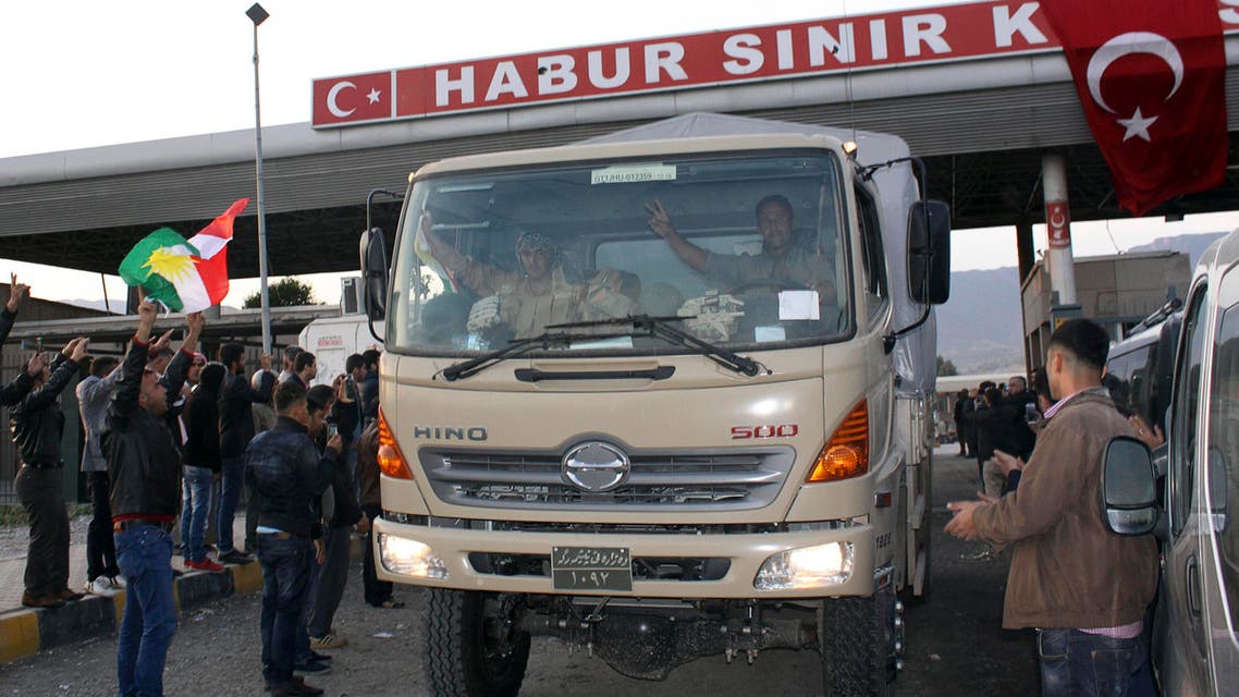 A convoy of peshmerga vehicles is welcomed by Turkish Kurds at Habur border gate, which separates Turkey from Iraq, near the town of Silopi in southeastern Turkey, October 29, 2014. reuters