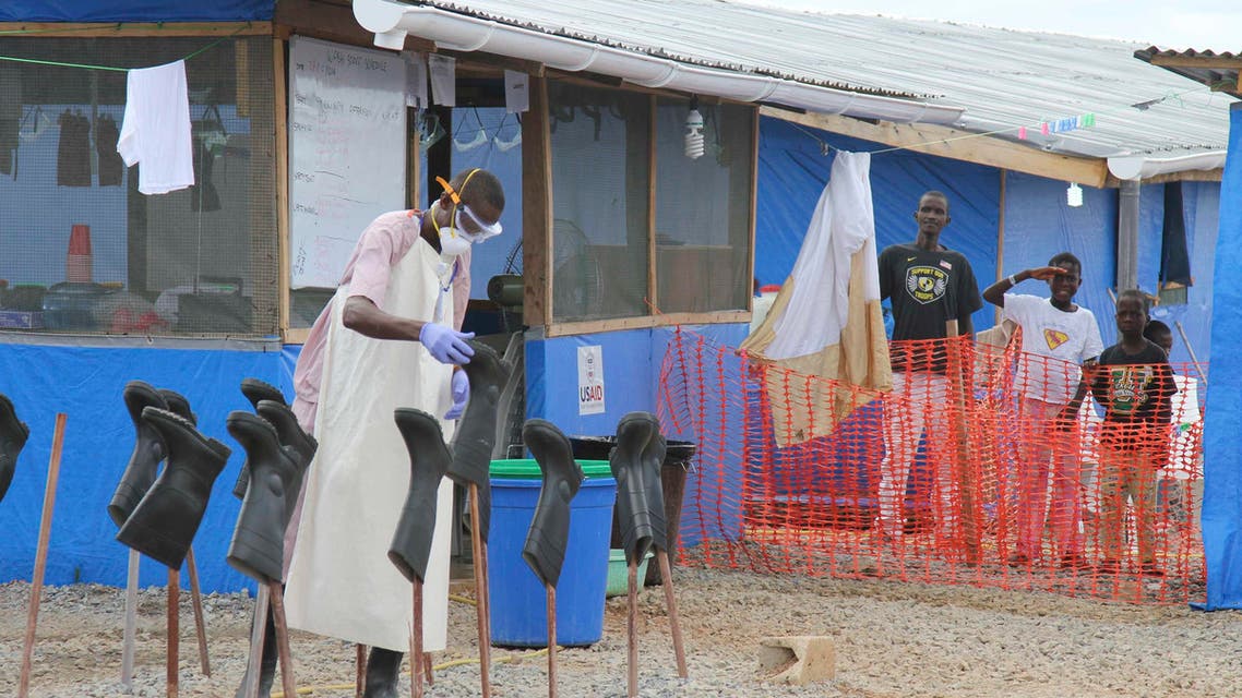 Boys Solomon (C, rear) and Joe (R, rear) stand in a zone where they are being treated for Ebola at a center about 200 km east of the capital, Monrovia, in this October 28, 2014 file photo. (Reuters)
