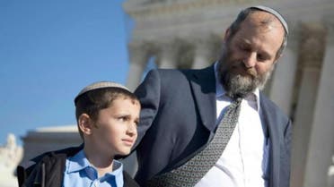 Ari Zivotofsky (right), stands with his nine-year-old son, Menachem, outside the Supreme Court in Washington, DC, November 7, 2011. (Photo courtesy: AP)