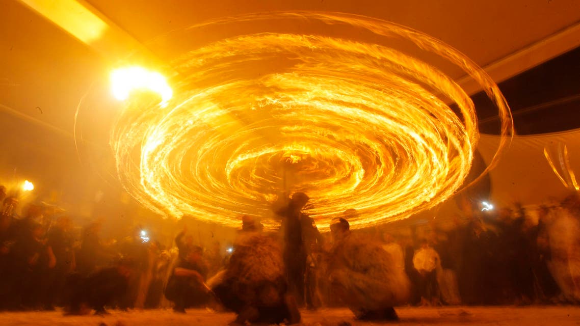 Shiite Muslims perform with fire during commemorations for Ashoura in Najaf, November 3, 2014. (Reuters)
