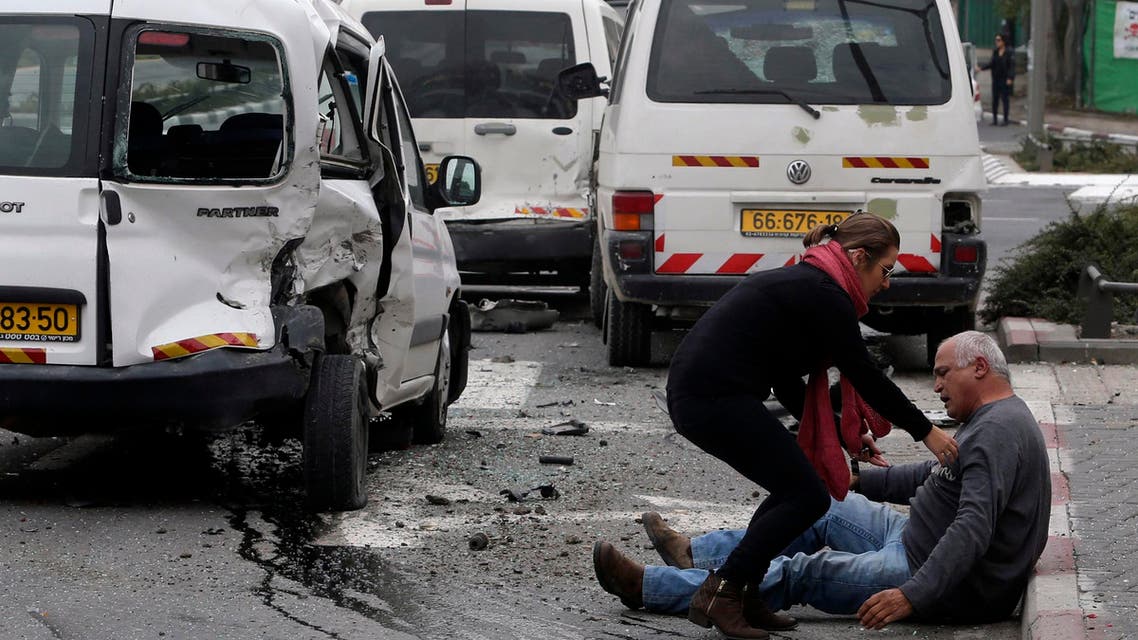 A wounded man sits on the street after an attack by a Palestinian motorist in Jerusalem November 5, 2014. (Reuters)