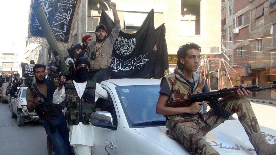 Islamic fighters from the Al-Qaeda-linked Al-Nusra Front drive through the Yarmuk refugee camp on the outskirts of Damascus, on July 28, 2014. (AFP)