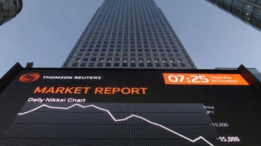 The market report is displayed on a screen in London's financial district of Canary Wharf early morning Oct. 16, 2014. (AFP)