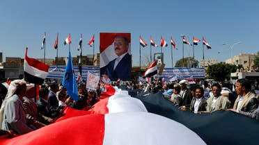 Supporters of Yemen's former President Ali Abdullah Saleh hold a huge Yemeni flag next to a poster of Saleh as they rally in his support in Sanaa November 7, 2014.
