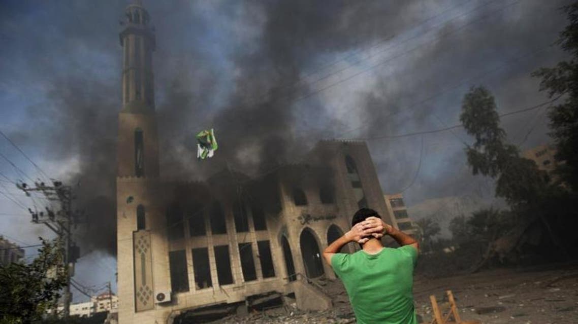 A Palestinian man reacts in front of a destroyed mosque after it was hit by an Israeli air strike, on July 29, 2014, in Gaza City. (AFP)
