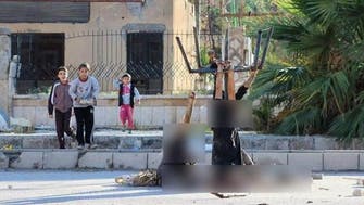 Shocking ISIS photo: children gaze at decapitated men