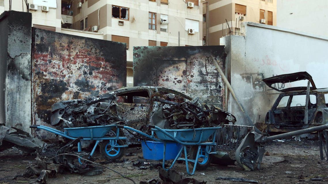 A destroyed vehicle is seen near the compound of the Egyptian embassy in the Libyan capital Tripoli on November 13, 2014 after it was targeted by a car bomb explosion. AFP