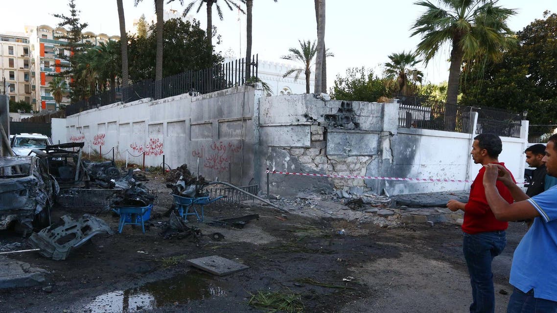 A destroyed vehicle is seen near the compound of the Egyptian embassy in the Libyan capital Tripoli on November 13, 2014 after it was targeted by a car bomb explosion. AFP
