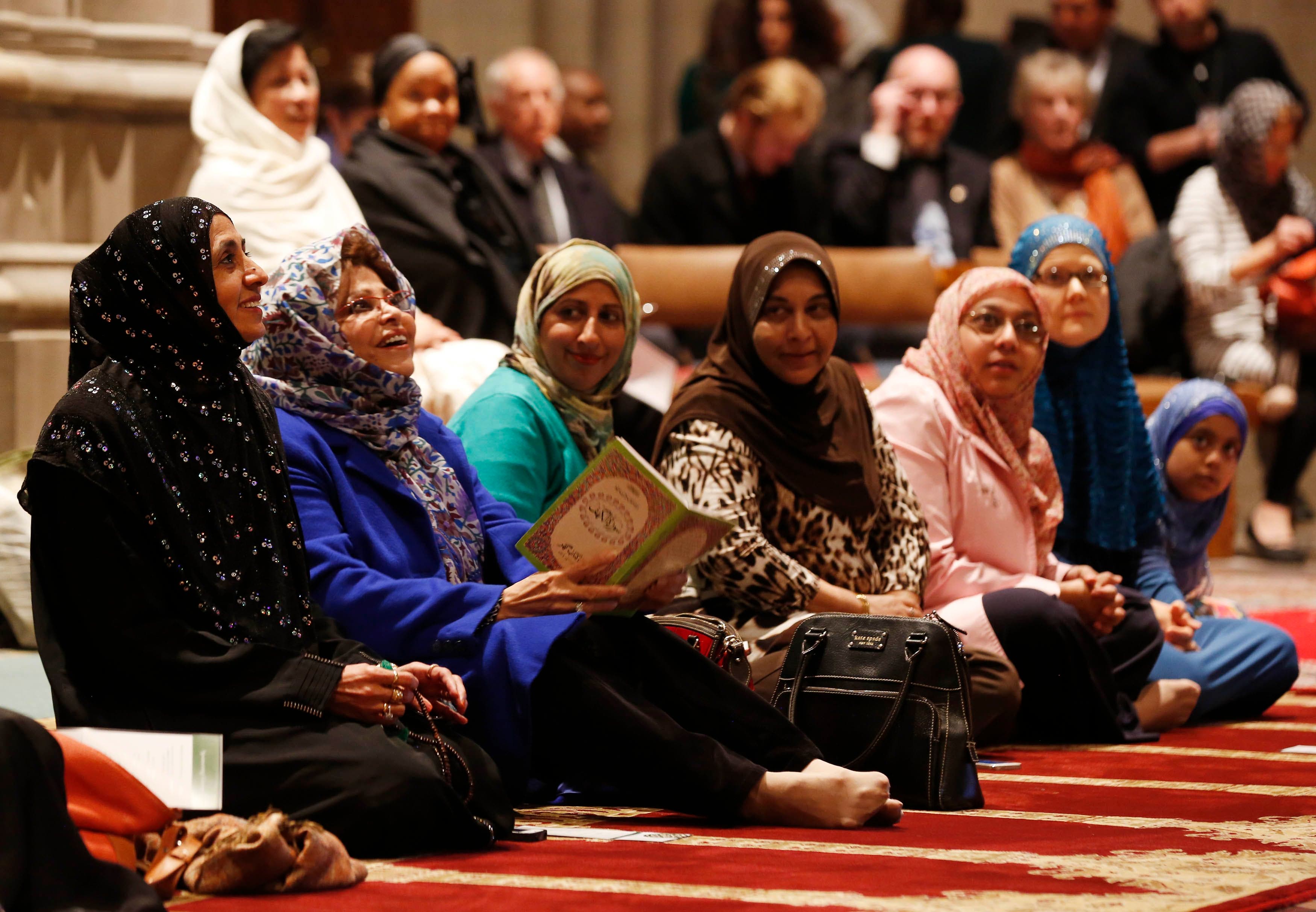 Women talk as the Washington National Cathedral and five Muslim groups hold the first celebration of Muslim Friday Prayers, Jumaa, in the Cathedral's North Transept in Washington, November 14, 2014. (Reuters)