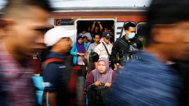 Commuters arrive at Tanah Abang train station in Jakarta November 13, 2014.