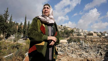 Palestinian Um Issam stands near the rubble of her demolished house in the East Jerusalem neighbourhood of Abu Tor November 4, 2014. (Reuters)
