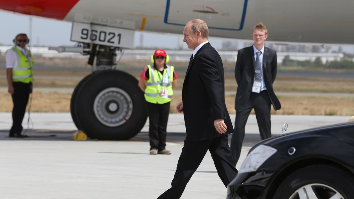 Russia’s President Vladimir Putin (C) crossing the tarmac as he prepares to leave, at the airport in Brisbane following the G20 Summit. AFP