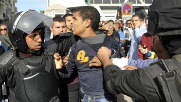 Egyptian police detain a supporter of the Muslim Brotherhood during clashes in Alexandria on January 23, 2014. AFP 