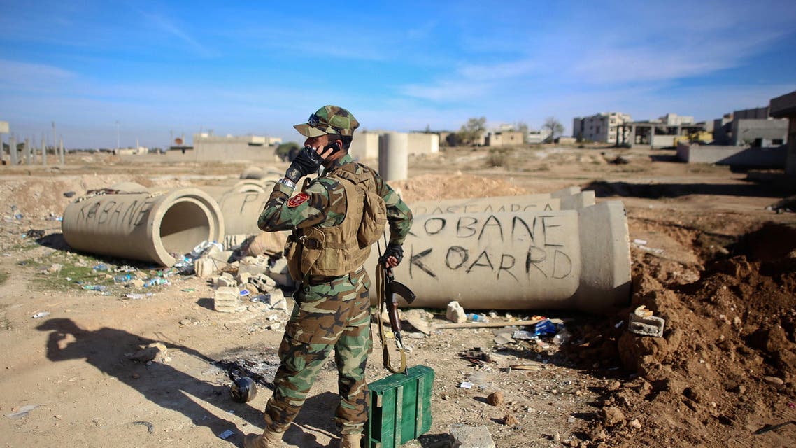 AD12 - Ain al-Arab, -, SYRIA : (FILES) - A file picture taken on November 8, 2014, shows a Kurdish Peshmerga fighter talking on the phone during fighting against Islamic State (IS) group in the Syrian besieged border town of Ain al-Arab (known as Kobane by the Kurds). US-led air strikes hit jihadist positions in the north and east of Syria, including an oil field, the Syrian Observatory for Human Rights said. AFP PHOTO / AHMED DEEB