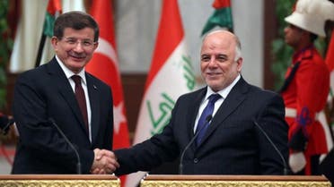  A handout picture made available by the Iraqi Prime Minister's Office on November 20, 2014 shows Iraq's Prime Minister Haidar al-Abadi (R) shaking hands with his Turkish counterpart Ahmet Davutoglu in Baghdad. AFP 
