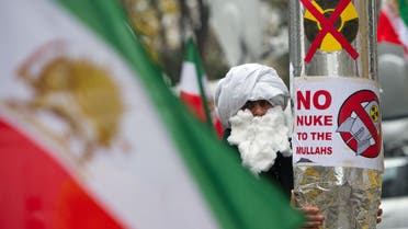  A demonstrator holds a mock-up of a nuclear missile with the lettering 'No nuke to the mullahs' as he protests against Iran's nuclear program and regime in front the Palais Coburg in Vienna on November 22, 2014. (AFP)
