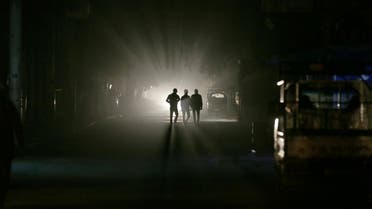 Men walk along a street at night in eastern al-Ghouta, near Damascus November 19, 2014. (Reuters)