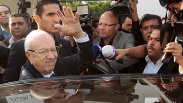 Beji Caid Essebsi (L), leader of Tunisia's secular Nidaa Tounes party and a presidential candidate, gestures after casting his vote at a polling station in Tunis Nov. 23, 2014. (AFP)