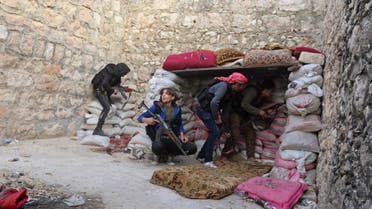 Rebel fighters take up position behind piles of sandbags on the Karm al-Tarab frontline, next to Aleppo International airport November 23, 2014. REUTERS/Abdalrhman Ismail (SYRIA - Tags: CIVIL UNREST CONFLICT)