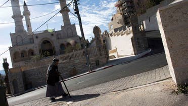A man walks past a new mosque in the Israeli Arab village of Abu Ghosh, near Jerusalem in this November 22, 2013 file photo. (Reuters)