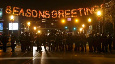 Police form a line in the street under a holiday sign after a grand jury returned no indictment in the shooting of Michael Brown in Ferguson, Missouri November 24, 2014. (Reuters)