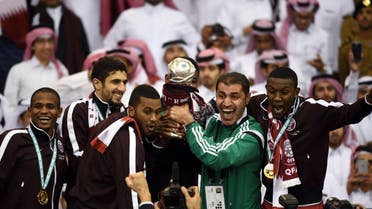  Qatar players carry the Gulf cup trophy after defeating Saudi Arabia 2-1 in the final of the 22nd Gulf Cup football match at the King Fahad stadium in Riyadh, on Nov. 26, 2014. (Qatar)