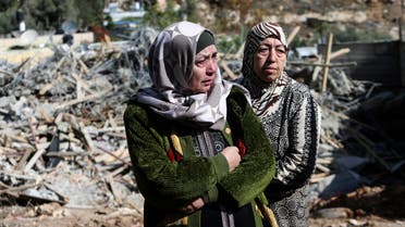 Palestinian Um Issam (L) stands with a relative near the rubble of her demolished house in the East Jerusalem neighbourhood of Abu Tor November 4, 2014. (Reuters)
