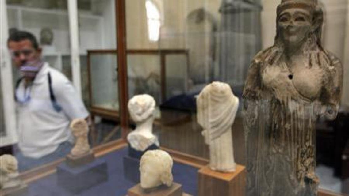 A visitor looks at exhibits inside the Egyptian Museum in Cairo April 7, 2010. (Reuter)