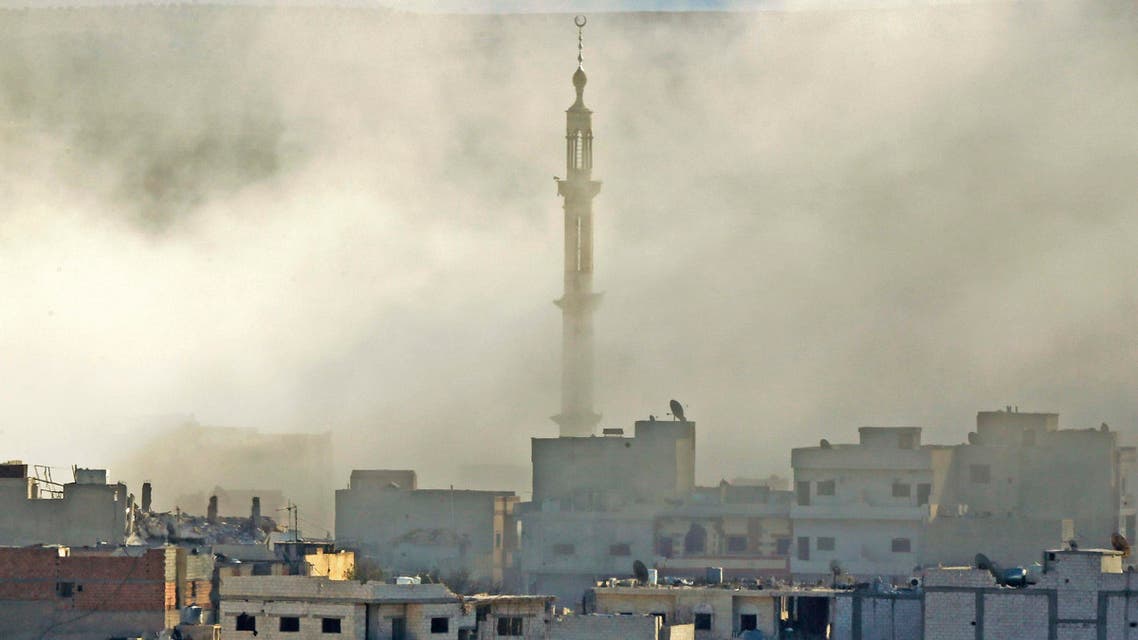 Thick smoke engulfs the minaret of a mosque following an air-strike in eastern Kobani on November 9, 2014. (Reuters)