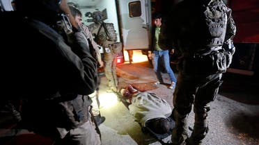 The dead body of a foreigner lies on the ground after a Taliban attack on a foreign aid workers' guest house in the Afghan capital of Kabul November 29, 2014.  (Reuters)