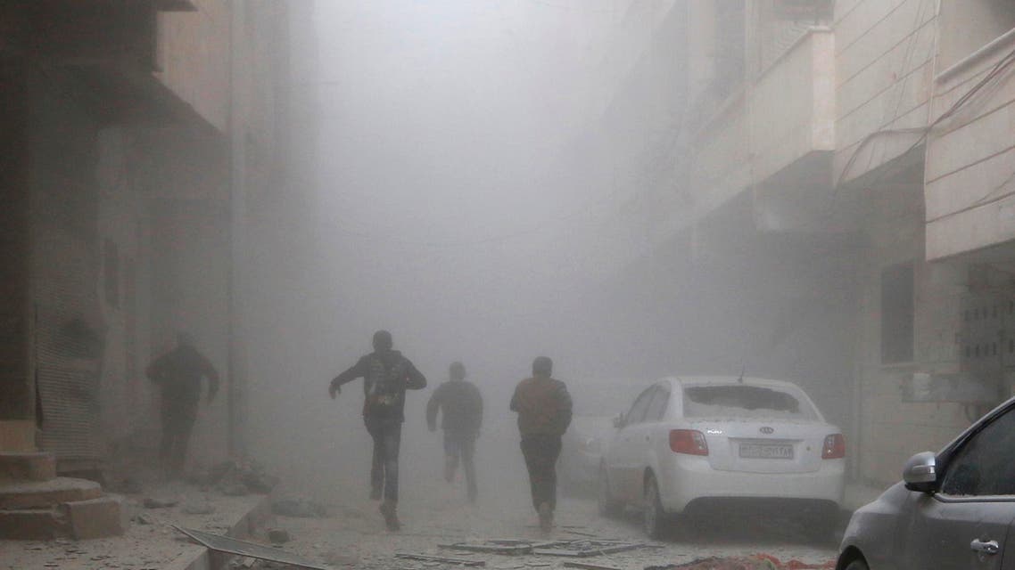 People run amid smoke from a site hit by what activists said were air strikes by forces loyal to Syria's President Bashar al-Assad in Raqqa, eastern Syria, which is controlled by the ISIS November 27, 2014. (Reuters)