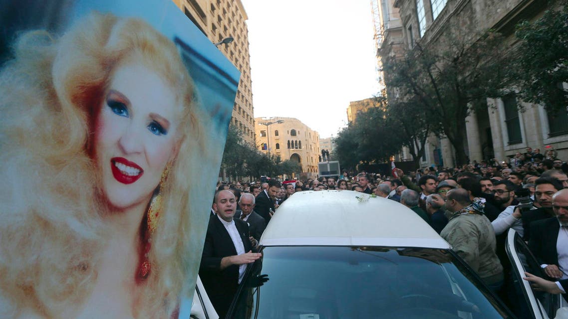 Residents carry a picture of Lebanese singer Sabah during her funeral in Beirut November 30, 2014. (Reuters)