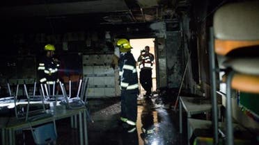 Emergency responders put out the fire which started in the school’s playground. (Photo courtesy: Tali Meir/Haaretz)