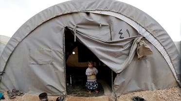 A child, who is internally displaced due to fighting between rebels and forces loyal to Syrian President Bashar al-Assad, peeks out from a tent at the Jarjanaz refugee camp in Idlib November 30, 2014. (Reuters)