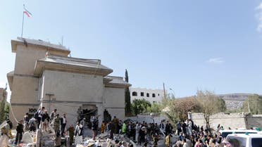 Police and onlookers gather at the damaged residence of the Iranian ambassador after a car bomb attack in Sanaa Dec. 3, 2014. (Reuters)