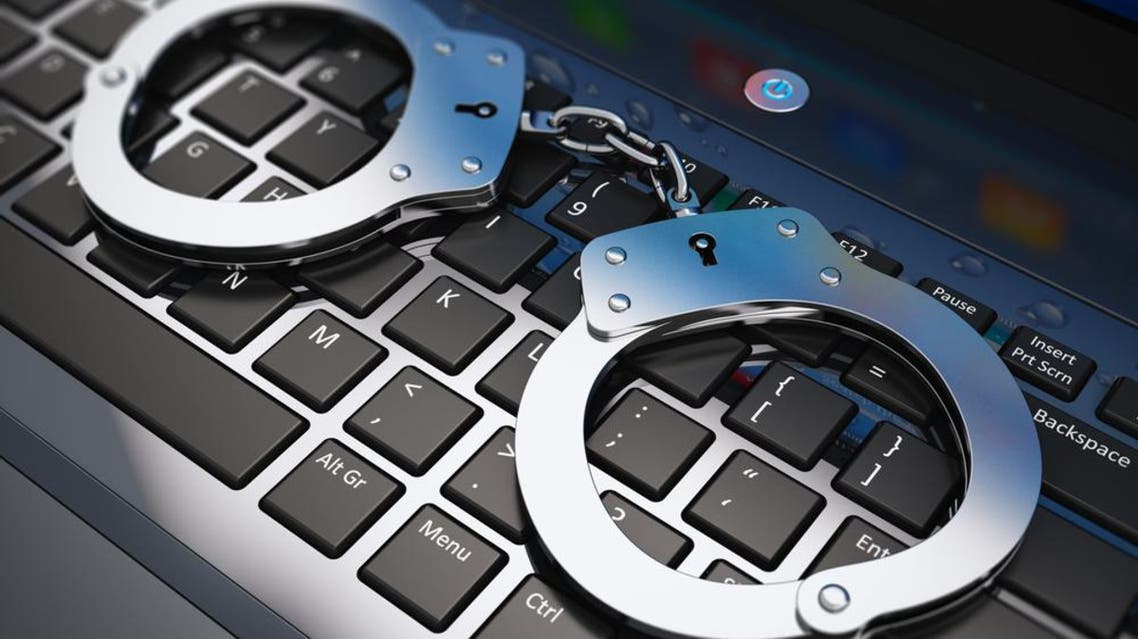 An illustrative image depicted a pair of handcuffs on a computer keyboard. (Shutterstock)