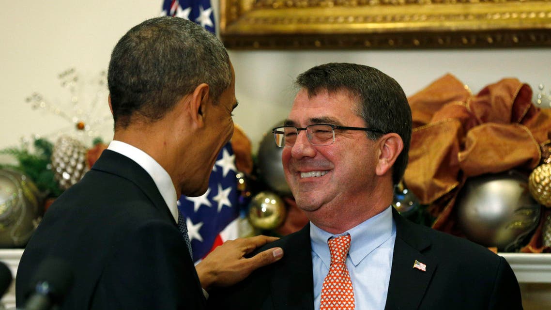 U.S. President Barack Obama puts his hand on the shoulder of former Pentagon official Ash Carter after nominating Carter to be his next defense secretary, at the White House in Washington Dec. 5, 2014. (AFP)