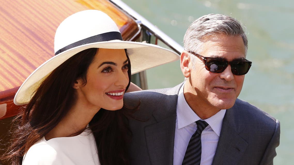 US actor George Clooney and British lawyer Amal Alamuddin leave the palazzo Ca Farsetti on a taxi boat on September 29, 2014 in Venice. (AFP)