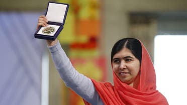 Nobel Peace Prize laureate Malala Yousafzai displays her medal during the Nobel Peace Prize awards ceremony at the City Hall in Oslo, Norway, on December 10, 2014. (AFP)