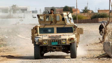 Military vehicles of the Iraqi security forces make their way on the outskirts of Baiji, north of Baghdad, December 8, 2014. (Reuters)