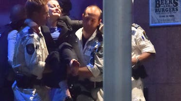 An injured hostage is carried out of a cafe in the central business district of Sydney on December 16, 2014. (AFP)