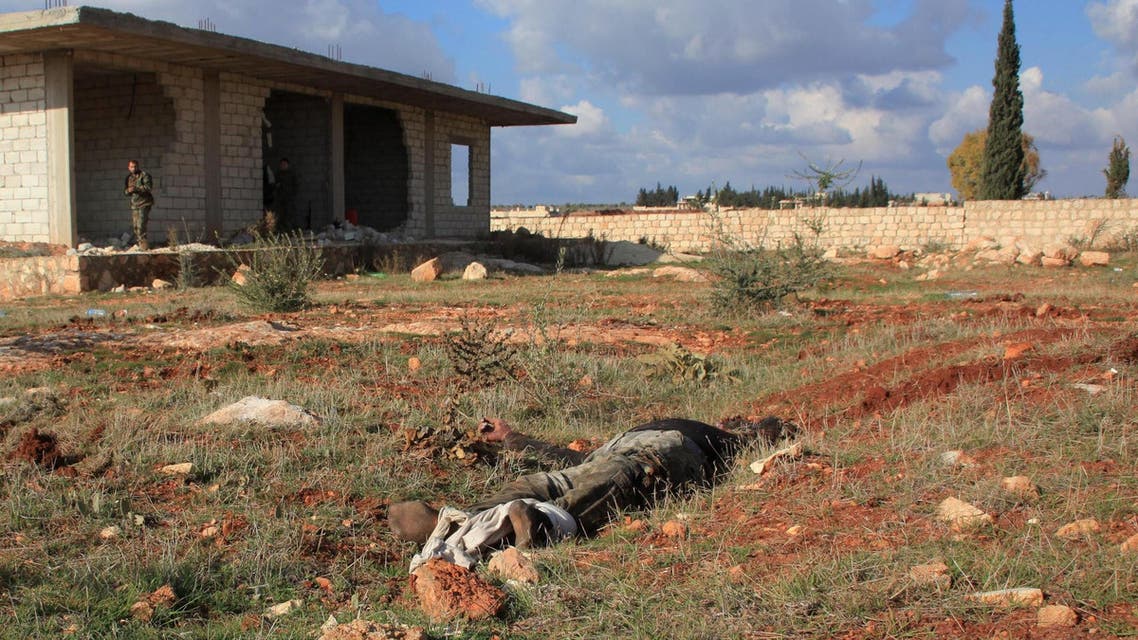 The body of an alleged rebel fighter lies on the ground during an operation by Syrian regime forces to take control of the Al-Maleh farms, west of the Handarat hill which is located just north of Aleppo, on December 15, 2014. (AFP)