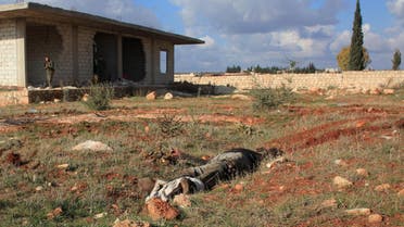  The body of an alleged rebel fighter lies on the ground during an operation by Syrian regime forces to take control of the Al-Maleh farms, west of the Handarat hill which is located just north of Aleppo, on December 15, 2014. (AFP)