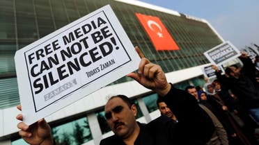 Zaman media group employees hold banners outside the headquarters of Zaman daily newspaper in Istanbul December 14, 2014. (Reuters)