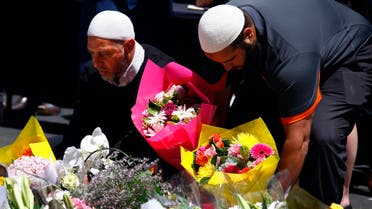 Members of the Australian Muslim community place floral tributes amongst thousands of others near the Lindt cafe, where hostages were held for over 16-hours, in central Sydney December 16, 2014. Reuters