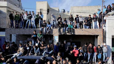 People watch the funeral of Palestinian Mahmoud Adwan in Qalandia refugee camp near the West Bank city of Ramallah December 16, 2014. (Reuters)