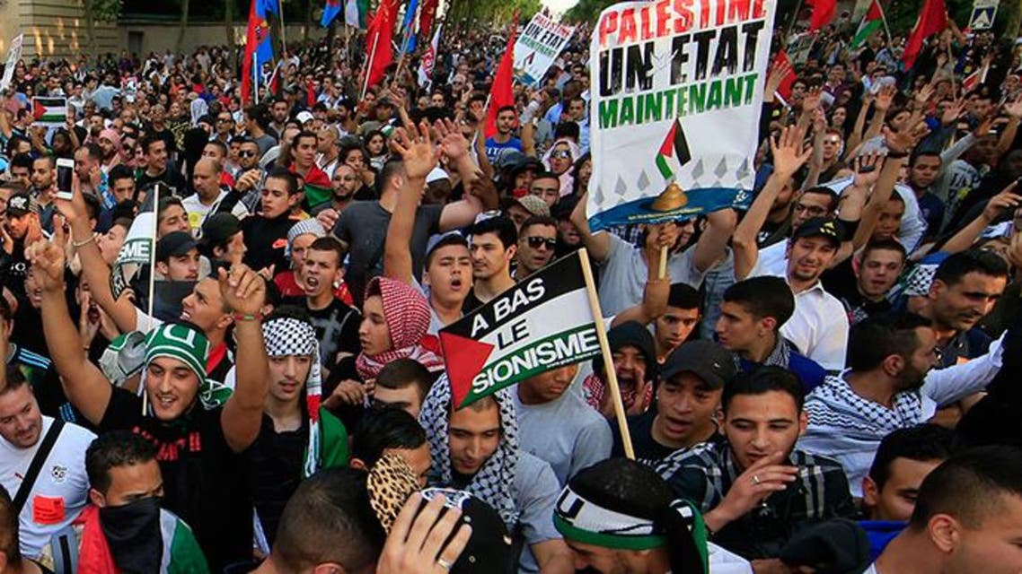 ARCHIVE PHOTO: Pro-Palestinian protesters hold boards reading: " Palestine, a state now" (R) and: "down with zionism" during a demonstration, which had been authorized by police, against violence in the Gaza strip, in Paris July 23, 2014. Reuters