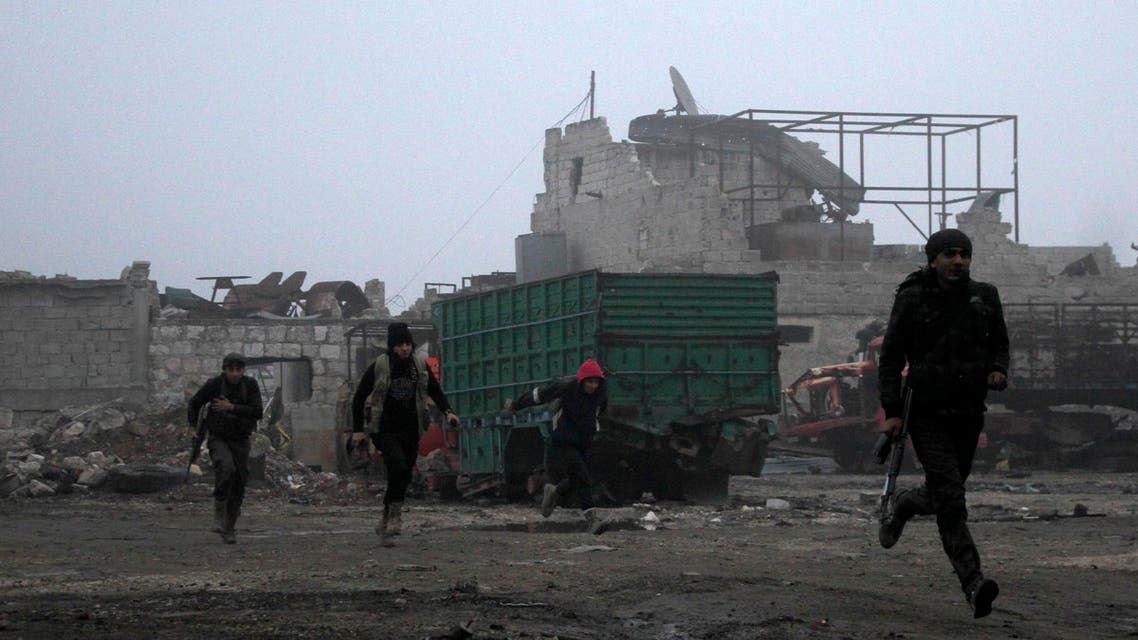 Rebel fighters run for cover during clashes with forces loyal to Syria's President Bashar al-Assad in Ramouseh, an area located beside Aleppo Artillery school December 21, 2014. (Reuters)