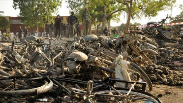 Police officers stand near wreckage at a scene of multiple bombings at Kano Central Mosque, Nigeria, Nov. 28, 2014. (Reuters) 